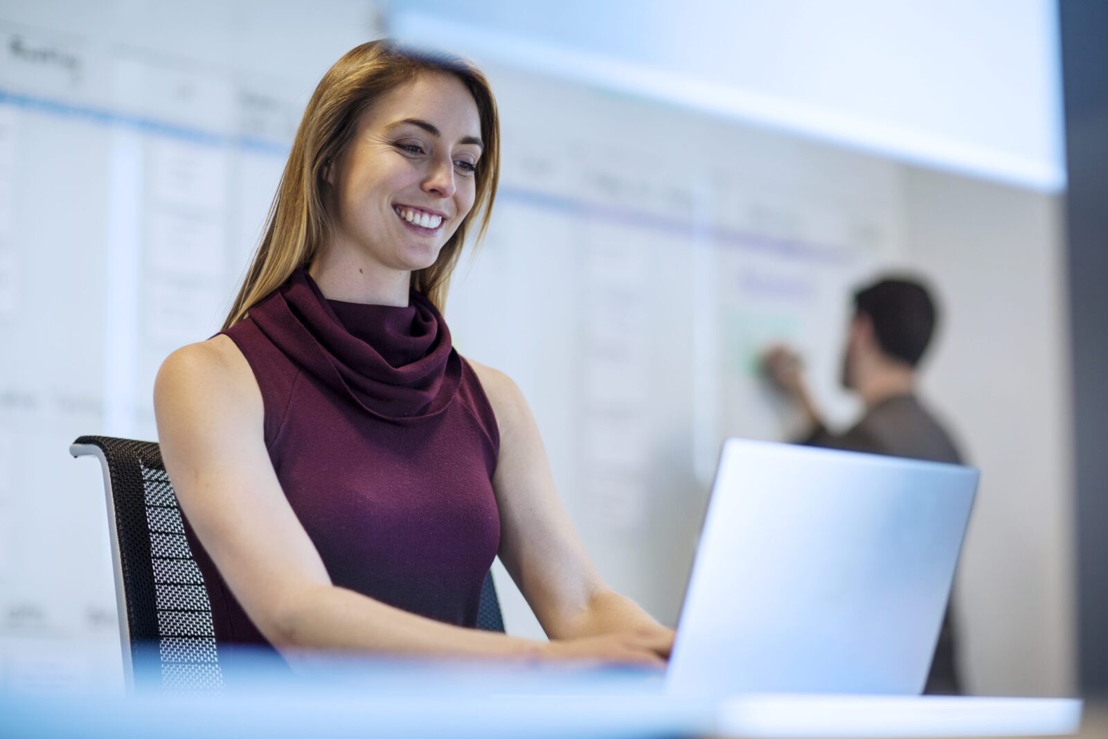 Young woman working in office with a colleague